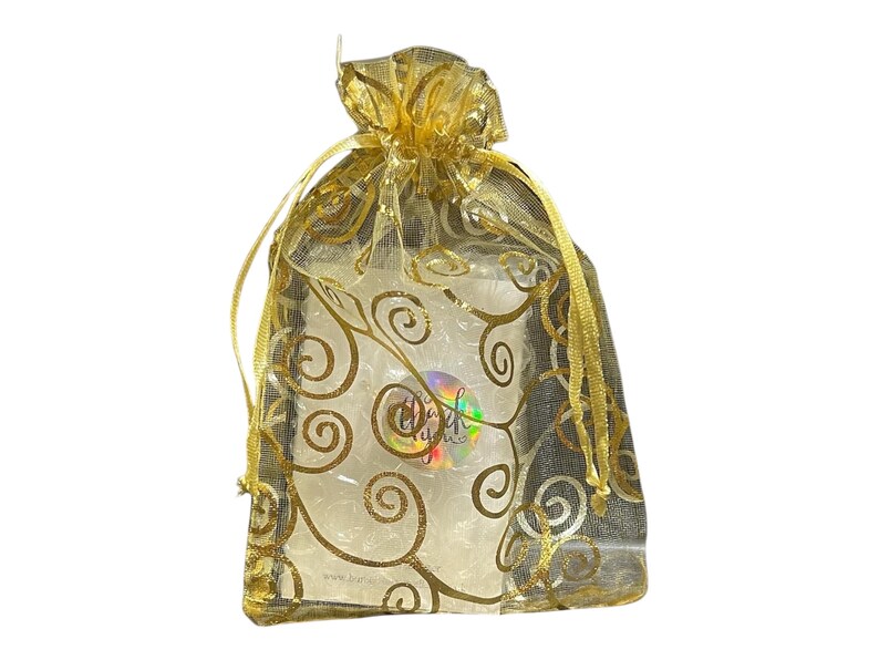 May include: A gold organza gift bag with a gold swirl pattern. The bag is tied with a gold ribbon.