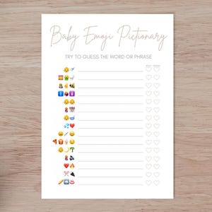 May include: A printable baby shower game with the title "Baby Emoji Pictionary". The game instructs players to "Try to guess the word or phrase" and includes a list of emojis and a space for players to write their guesses.
