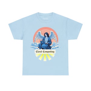 May include: Pale blue t-shirt with a graphic of an angel using a laptop, set against a sunset and clouds. The design includes the words "Cloud Computing" in a banner with yellow rays.