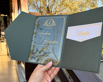 Acrylic invitation with gold foil printing, featuring a green pocket envelope, detail card, wax seal.
