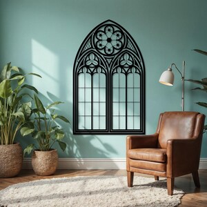 May include: A black, gothic-style window wall decor piece. The design features an arched top with intricate floral and geometric patterns. The window has two panes with a grid pattern, creating a striking contrast against the light-colored wall.