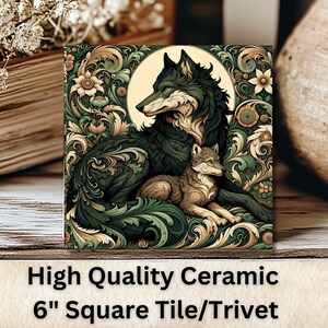 May include: A 6-inch square ceramic tile or trivet featuring a detailed illustration of a wolf and a wolf pup surrounded by intricate floral designs. The background is a light brown with a moon shape.