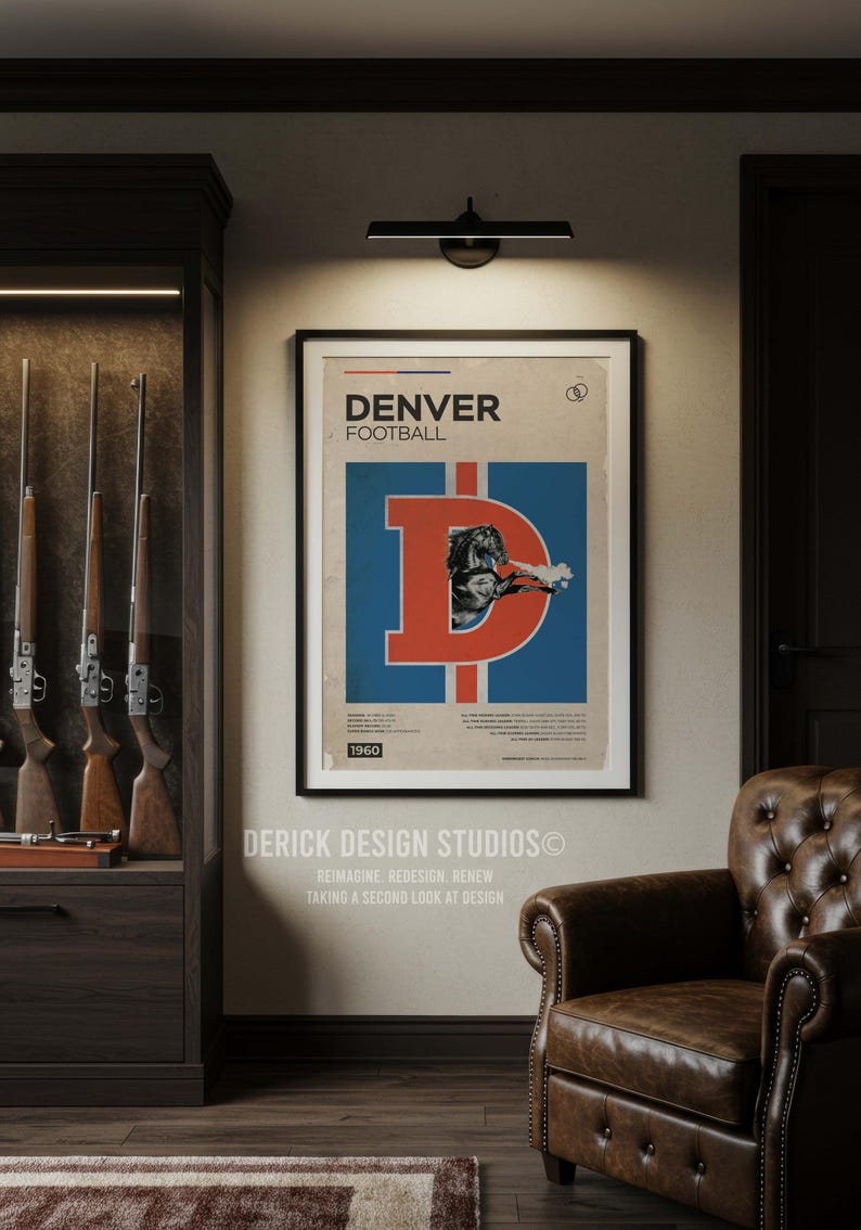 May include: Framed vintage Denver Broncos football poster. The poster features a large orange "D" with a football player image on a blue background. The poster is dated 1960. The room also includes a leather armchair and a cabinet with rifles.