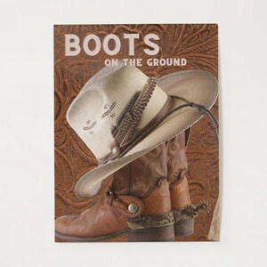 May include: A rustic image featuring a cowboy hat with feather accents resting on top of a pair of brown leather cowboy boots. The boots have decorative stitching and spurs. The background has the words "BOOTS ON THE GROUND".