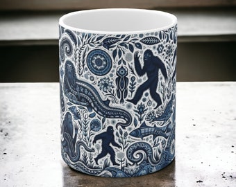 Cryptid woods in blue 11oz mug with mothman, bigfoot, the jersey devil, jackalope, and the frogman of loveland