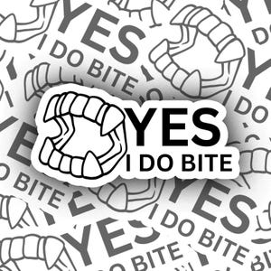 May include: A black and white sticker with the text "YES I DO BITE" and a graphic of a set of fangs.
