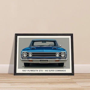 May include: Framed print of a blue 1967 Plymouth GTX 440 Super Commando. The classic car is depicted head-on, showcasing its headlights, grille, and hood scoops. The print is in a black frame and features the car's model information at the bottom.