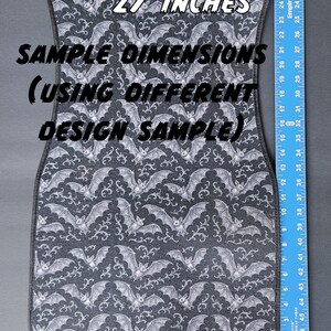 May include: A car floor mat with a repeating pattern of white bats on a dark gray background. The mat is approximately 27 inches long. The text "SAMPLE DIMENSIONS (USING DIFFERENT DESIGN SAMPLE)" is visible.