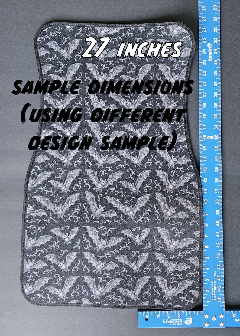 May include: A car floor mat with a repeating pattern of white bats on a dark gray background. The mat is approximately 27 inches long. The text "SAMPLE DIMENSIONS (USING DIFFERENT DESIGN SAMPLE)" is visible.
