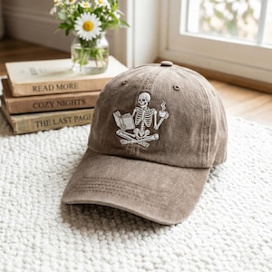 Embroidered Skeleton Reading a Book Hat, Book Lover Hat Cozy Aesthetic Embroidery Dark Academia Spooky Season Reader Cap