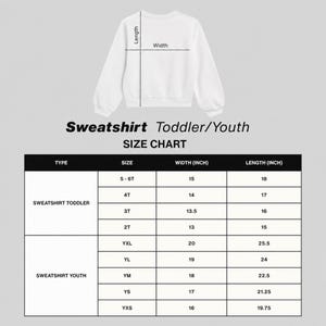 May include: A white long-sleeve sweatshirt displayed above a size chart for toddler and youth sizes. The chart lists width and length measurements in inches for sizes 2T through 6T and YXS through YXL, showing how to measure the garment.