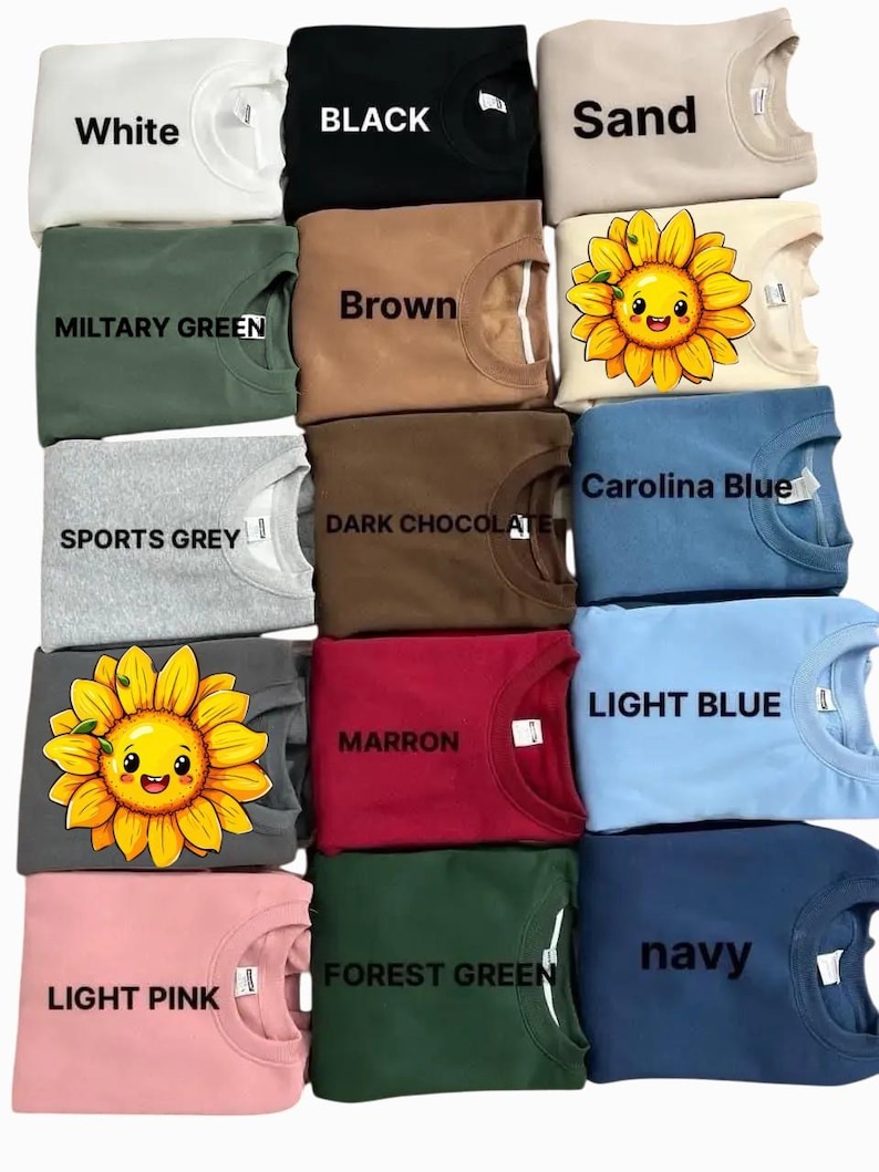 May include: A collection of 12 crew neck sweatshirts in various colors, including white, black, sand, brown, military green, sports grey, dark chocolate, carolina blue, light blue, maroon, forest green, and navy. Some sweatshirts feature a cartoon sunflower graphic.
