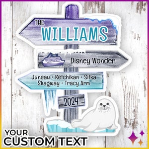 May include: A blue and white wooden sign with the text "THE WILLIAMS" on the top. The sign has three arrows pointing in different directions. The top arrow points to the right and says "Disney Wonder". The middle arrow points to the left and says "Juneau Ketchikan Sitka Skagway Tracy Arm". The bottom arrow points to the right and says "2024". A white seal is sitting on a blue and white ice floe below the sign.