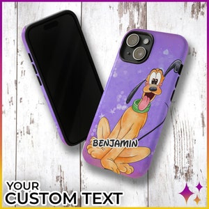 May include: Purple phone case featuring a cartoon image of Pluto the dog. The case has a white background with purple stars and the text "BENJAMIN".