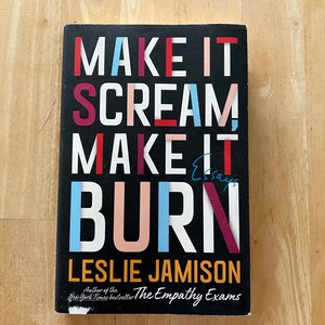 May include: A book cover with the title "Make It Scream, Make It Burn: Essays" by Leslie Jamison. The title is in large, colourful letters on a black background. The author's name is in orange letters below the title.