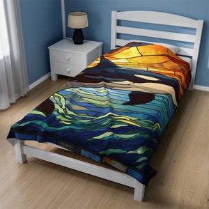 May include: A stained glass style throw blanket featuring a colorful depiction of an orca swimming in the ocean. The blanket is made of soft, plush fabric and is perfect for adding a touch of whimsy to any bedroom.