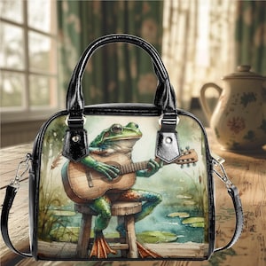 Bolso de hombro de cuero vegano de PU, tipo cartera, estilo mensajero, con forma de rana, estilo banjo o bolso de diario, tipo cartera, color negro, con un diseño divertido y lindo.