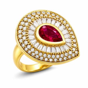 May include: A gold ring featuring a central pear-shaped red gemstone surrounded by a halo of baguette-cut white stones, followed by an outer border of round white stones. The setting is crafted in yellow gold with a smooth, polished band.