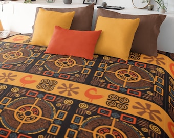 May include: A bed with a patterned blanket and pillows. The blanket features a repeating design in black, orange, and brown. The pillows are in shades of brown, orange, and yellow. The bed is against a white wall with plants and decorative items.