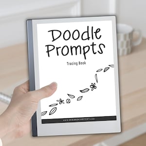 May include: A digital tablet displaying a white cover page with the black text Doodle Prompts Tracing Book, featuring a decorative line of black hand-drawn leaves and flowers across the centre and a website URL at the bottom edge.