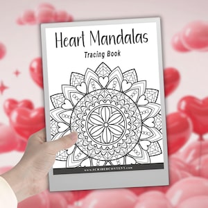 May include: A tracing book titled "Heart Mandalas" featuring a detailed black and white mandala design. The cover displays the title and the words "Tracing Book". The book is held against a backdrop of pink and red heart-shaped balloons.