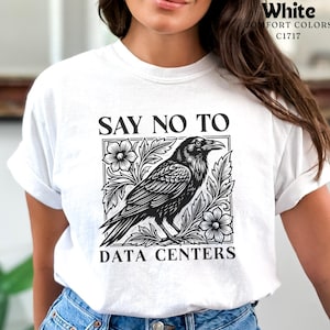 May include: A white short-sleeve t-shirt featuring a black graphic print of a raven surrounded by floral patterns. The text above the graphic reads "SAY NO TO" and the text below reads "DATA CENTERS". The shirt is labeled as Comfort Colors C1717.