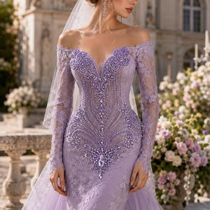 May include: A lavender off-the-shoulder gown featuring long lace sleeves, a sweetheart neckline, and intricate beadwork embellishments across the bodice. The dress includes a sheer veil and a layered tulle skirt with floral lace appliques.