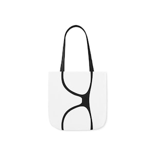 May include: A white tote bag with black handles and a black graphic of a pair of eyeglasses.