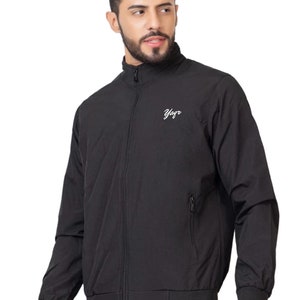 May include: A black zip-up jacket with a stand-up collar and a white logo that says "Yagr".