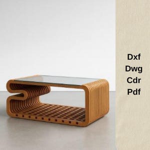 May include: A modern coffee table with a clear glass top and a light brown, layered wooden base. The base features a unique, curved design on one side and a grid-like pattern on the bottom. The table is approximately 48 inches long.
