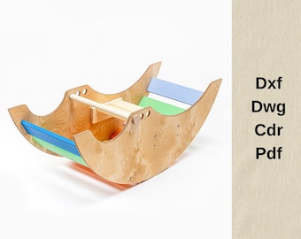 May include: A wooden rocking toy with a natural finish, featuring blue, green, and light blue accents. The toy has a curved design and a horizontal bar for support. The text "Dxf, Dwg, Cdr, Pdf" is visible on the right side.
