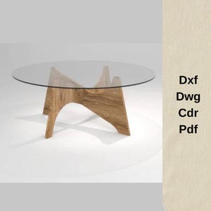 Puede incluir: Una mesa de centro contemporánea con una tapa redonda de cristal y una base de madera. La base tiene un diseño curvo y artístico. La mesa está sobre un fondo blanco. Texto a la derecha: Dxf, Dwg, Cdr, Pdf.