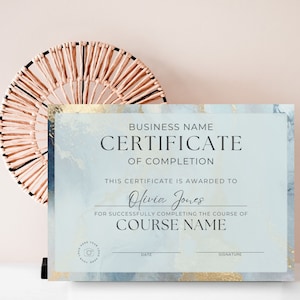 May include: A blue and gold marble-textured certificate of completion with the text "BUSINESS NAME CERTIFICATE OF COMPLETION" at the top. The certificate is awarded to "Olivia Jones" for successfully completing the course of "COURSE NAME".