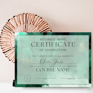 Peut inclure: Un certificat de réussite de couleur verte et dorée avec un fond aquarelle. Le texte indique "BUSINESS NAME CERTIFICATE OF COMPLETION THIS CERTIFICATE IS AWARDED TO Olivia Jones FOR SUCCESSFULLY COMPLETING THE COURSE OF COURSE NAME DATE SIGNATURE"
