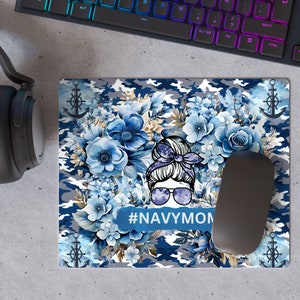 May include: A blue and gray camouflage mousepad with a floral design and a cartoon woman with a bun and sunglasses. The text "#NAVYMOM" is printed on the mousepad.