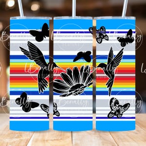 May include: Three stainless steel tumblers with a colorful striped design. The design features a hummingbird, butterflies, and a sunflower. The tumblers are perfect for holding hot or cold beverages.