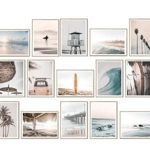 May include: A collection of 15 framed prints featuring beach scenes, including surfers, palm trees, waves, and a lifeguard stand. The prints are all in a similar style, with a light and airy feel.