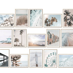 May include: A collection of 15 framed prints featuring beach scenes, including palm trees, ocean waves, a Ferris wheel, a lifeguard stand, and beach houses. The prints are all in a light, airy color palette and would be perfect for a coastal-themed home.
