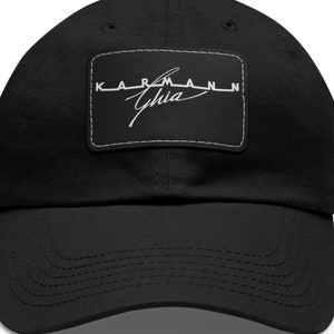 May include: Black cotton baseball cap with a white embroidered patch that says "KARMANN Ghia" in a vintage style font.