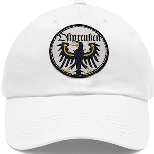 May include: White baseball cap with a black and yellow embroidered patch featuring a black eagle with the text "Diepreußen" in black.
