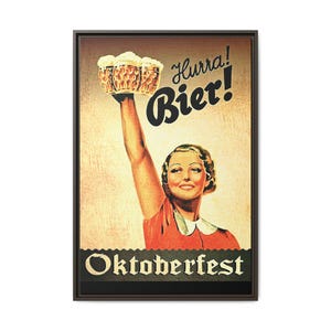 May include: A vintage-style rectangular wall art print featuring a person in a red shirt holding three beer mugs aloft. The text reads Hurra! Bier! at the top and Oktoberfest at the bottom. The background is a textured beige with a dark brown frame.