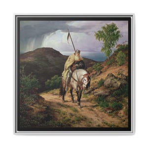May include: A framed print of an oil painting depicting a knight on horseback. The knight, wearing a helmet and cape, holds a spear with a black and white flag. The scene is set on a dirt path with a mountainous backdrop and stormy sky.