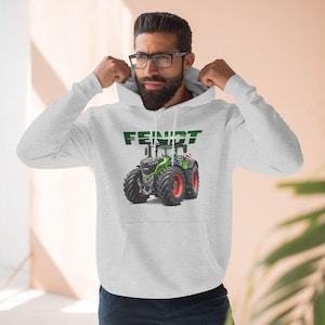 May include: A gray hooded sweatshirt with the word "FEINIDT" printed in green on the front. A green and black tractor is printed below the word.