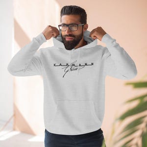 May include: A gray hooded sweatshirt with the text "KARMANN Ghia" in black lettering.