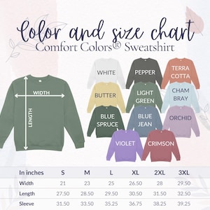 Op de afbeelding: Kleur- en maattabel voor Comfort Colors sweatshirts. De tabel toont verschillende kleuren, waaronder wit, boter, blauwspar, violet en karmozijn. De afmetingen zijn in inches voor breedte, lengte en mouwlengte, van maat S tot 3XL.
