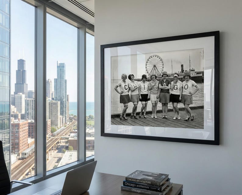 May include: A framed black and white photograph of seven women in matching outfits posing on a pier. The women wear skirts and shirts with the letters "C", "H", "I", "C", "A", and "G", "O". A Ferris wheel and a ship are visible in the background.