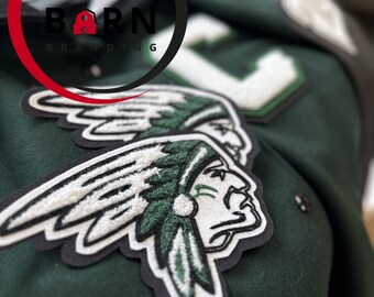 May include: Green and white embroidered patch of an American Indian with a feathered headdress. The patch is sewn onto a green fabric jacket with the text "RED BARN BRANDING" in a red circle.