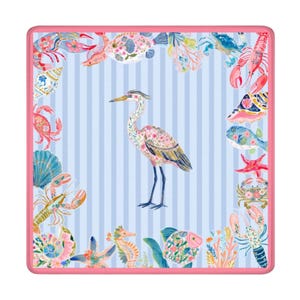 May include: A square textile featuring a central heron illustration on a light blue and white striped background. The border is decorated with colorful marine life including crabs, lobsters, fish, starfish, and seashells, all framed by a pink edge.