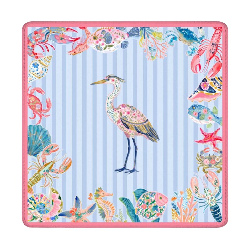 May include: A square textile featuring a central heron illustration on a light blue and white striped background. The border is decorated with colorful marine life including crabs, lobsters, fish, starfish, and seashells, all framed by a pink edge.