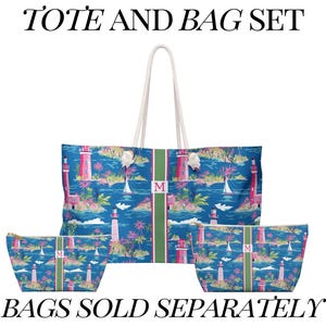 May include: A tote bag and two smaller pouches featuring a blue background with a lighthouse, sailboat, and palm tree pattern. Each item has a vertical green stripe with a pink letter M. The text TOTE AND BAG SET and BAGS SOLD SEPARATELY appears.